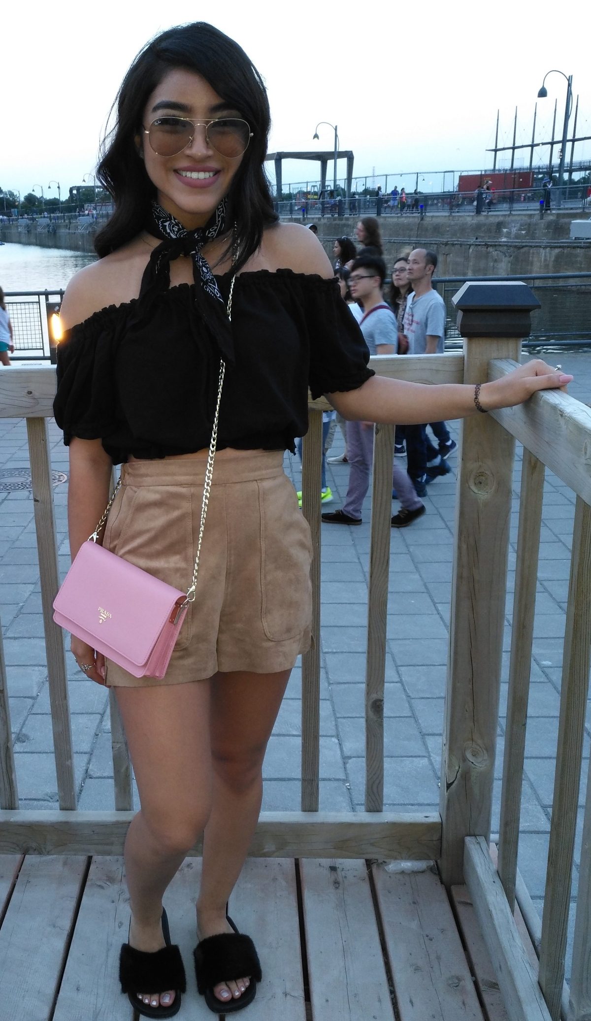 pink purse beige shorts and black top tourist fashion in Old Montreal