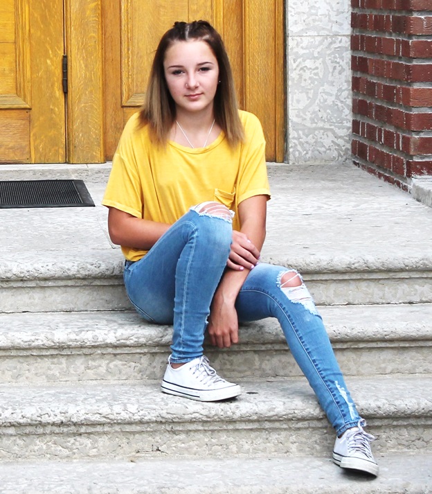 blong girl in yellow shirt on concrete steps forlorn emotion airdrie alberta church