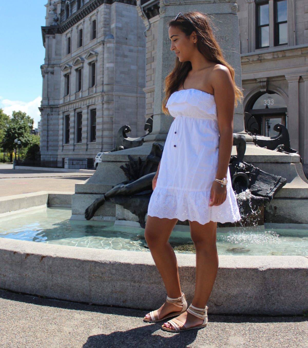 white cotton dress beside old fountain in Montreal